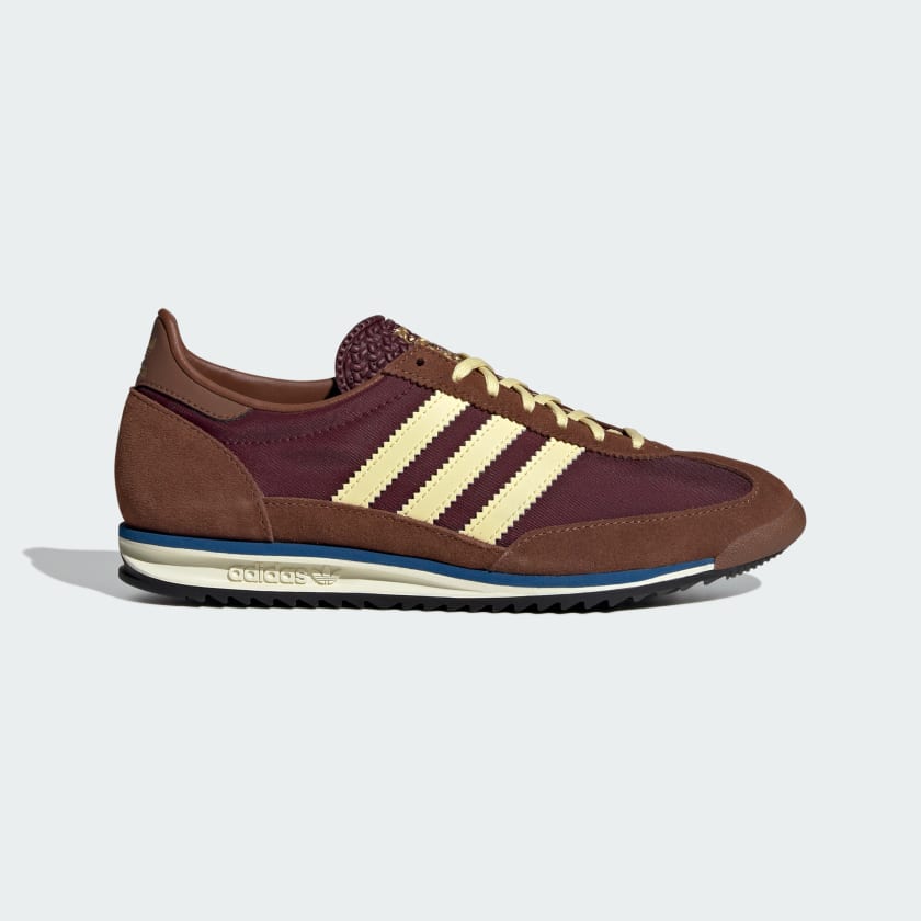 Brown Adidas Originals SL72 trainers. First released in 1972 to equip athletes for the Summer event, the adidas SL 72 shoes have a lightweight build that revolutionised running. Today, the breathable nylon upper, suede overlays and leather accents bring retro-inspired style to your active life. An Ecotex tongue adds texture, and the EVA midsole keeps you comfortable on the go. The classic low-profile cut and rubber outsole deliver the final touches.