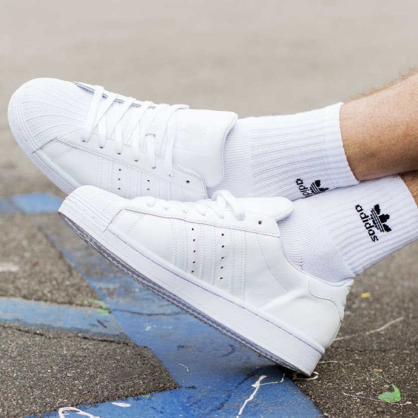 White adidas sneakers on feet