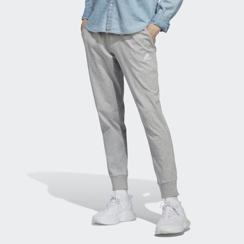 adidas Essentials Fleece Tapered Cuff Logo Pants Navy These pants are ultra  cozy and have sporty style that's undeniable. An oversize adidas Badge of  Sport and cuffed hems add to a fashion-forward