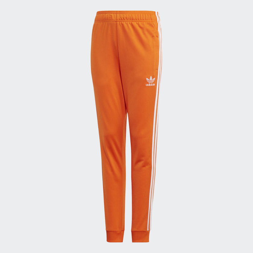 black and orange adidas track pants