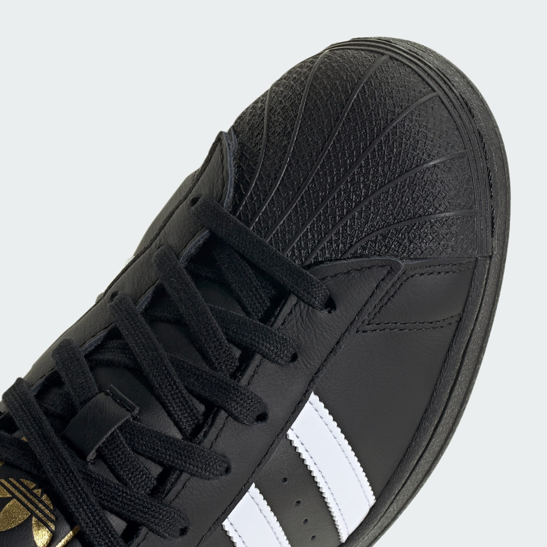 Adidas superstar black over shop white with gold detail