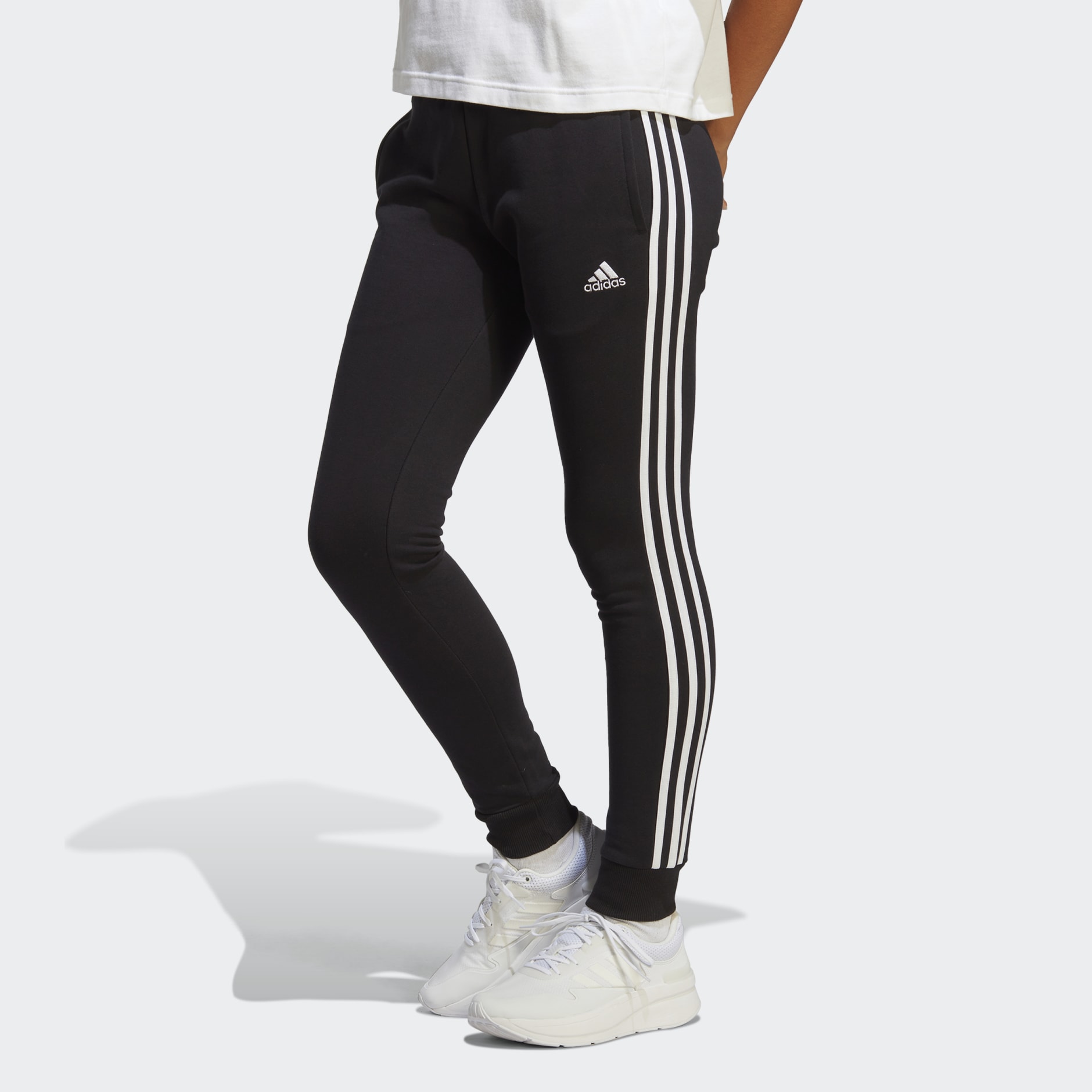 adidas Essentials 3-Stripes French Terry Cuffed Pants - Black | adidas UAE