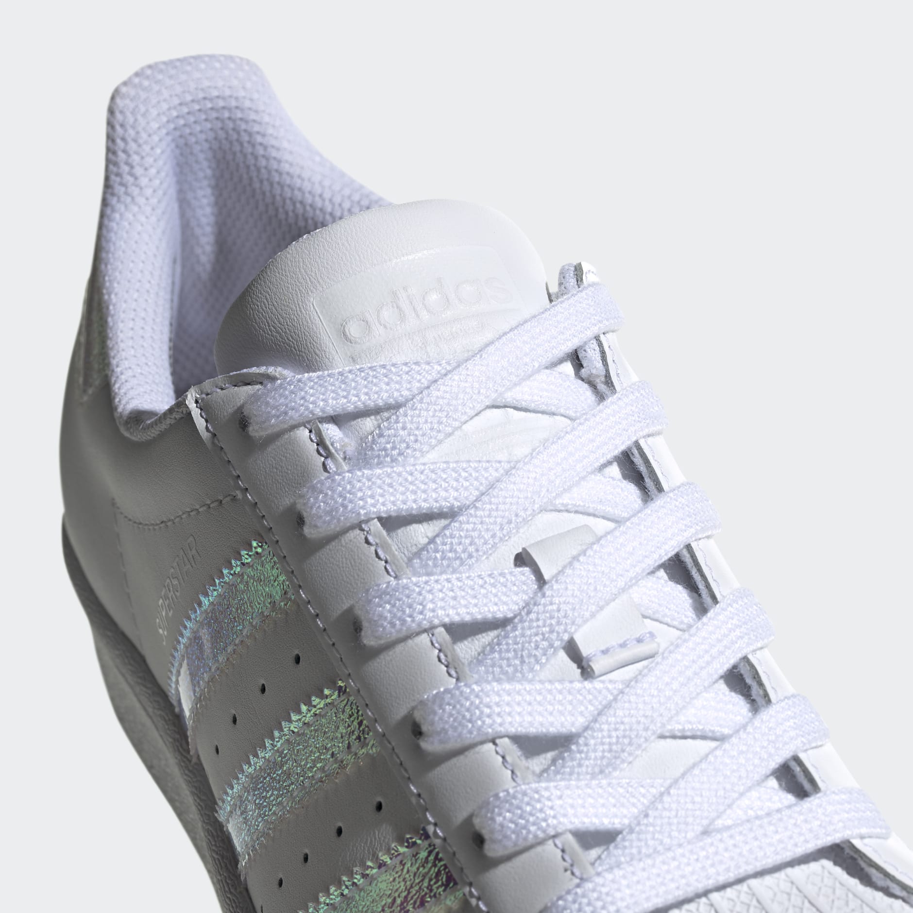 Originals junior superstar iridescent trainers in 2025 white and silver