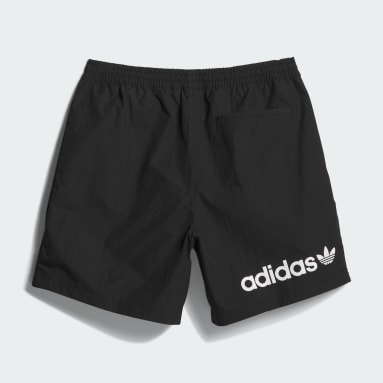 Un Homme Qui Court Portant Un Débardeur Et Un Short Avec Le Mot Adidas  Dessus.