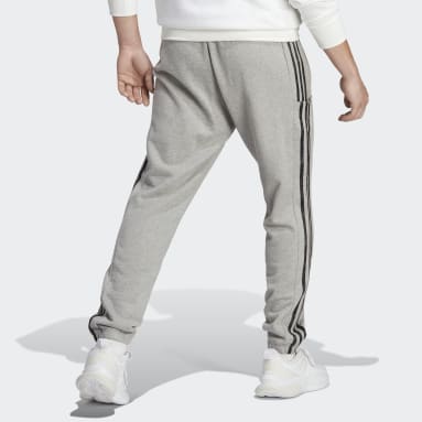 Pantalon fuselé en molleton aux chevilles élastiques et à 3 bandes Essentials gris Hommes Sportswear
