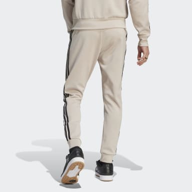 Muži Originals béžová Tepláky Adicolor Classics SST