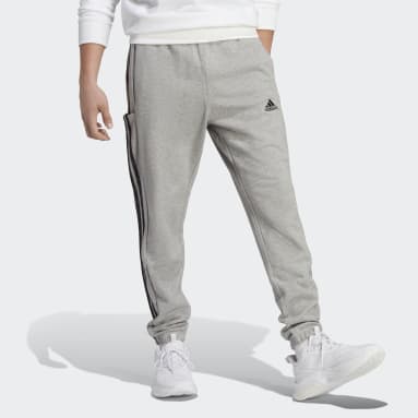 Pantalon fuselé en molleton aux chevilles élastiques et à 3 bandes Essentials gris Hommes Sportswear