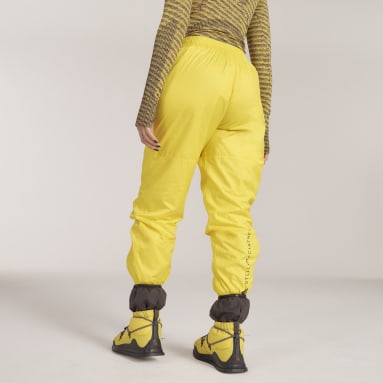 Ženy adidas by Stella McCartney žlutá Kalhoty adidas by Stella McCartney Woven Lined