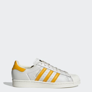 adidas white shoes with gold stripes