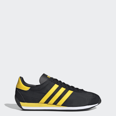 black and yellow adidas trainers