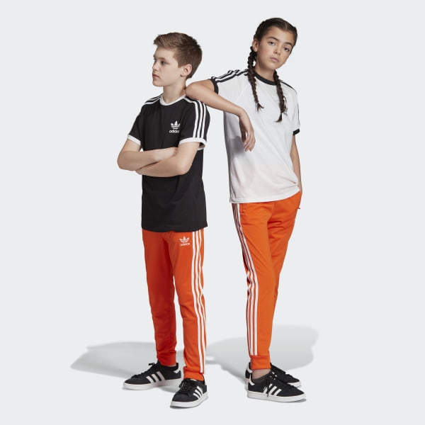 white and orange adidas pants