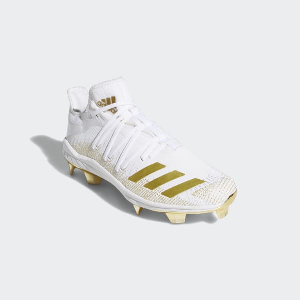 white and gold metal cleats