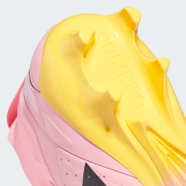 Pink and yellow football cleats top