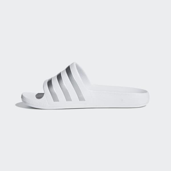 white and silver adidas slides