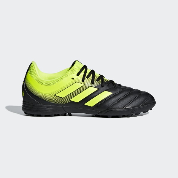 black and yellow turf shoes