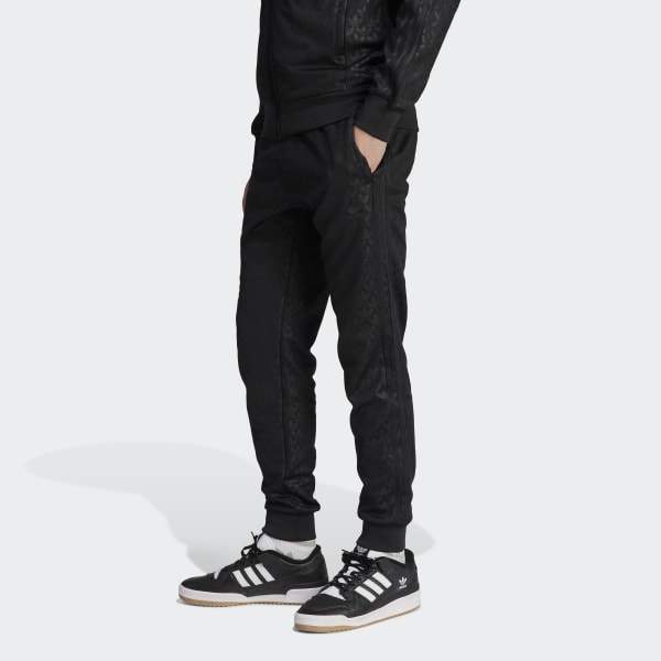Nike Monogram all over logo print fleece cuffed sweatpants in black