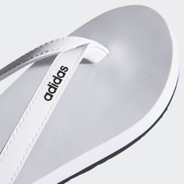 white and silver flip flops
