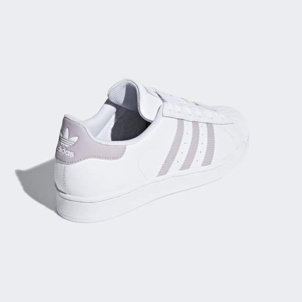 white adidas shoes with colorful bottoms