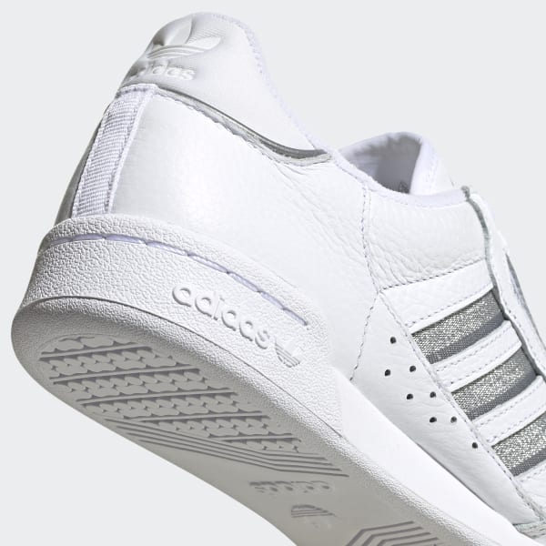 white adidas with silver stripes