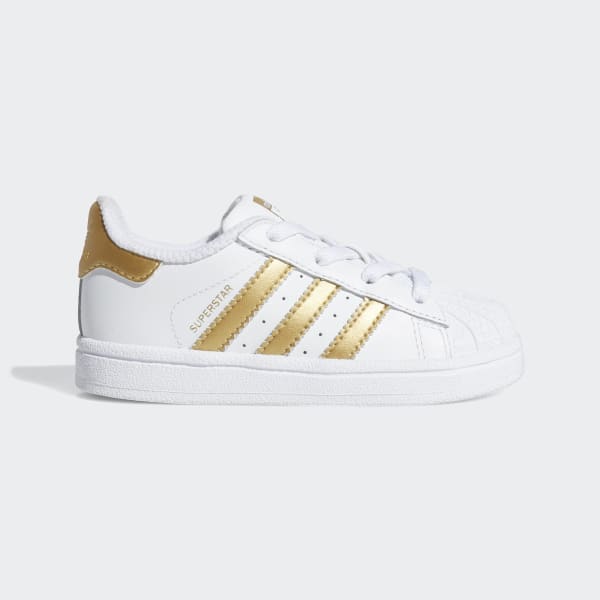 white adidas shoes with gold