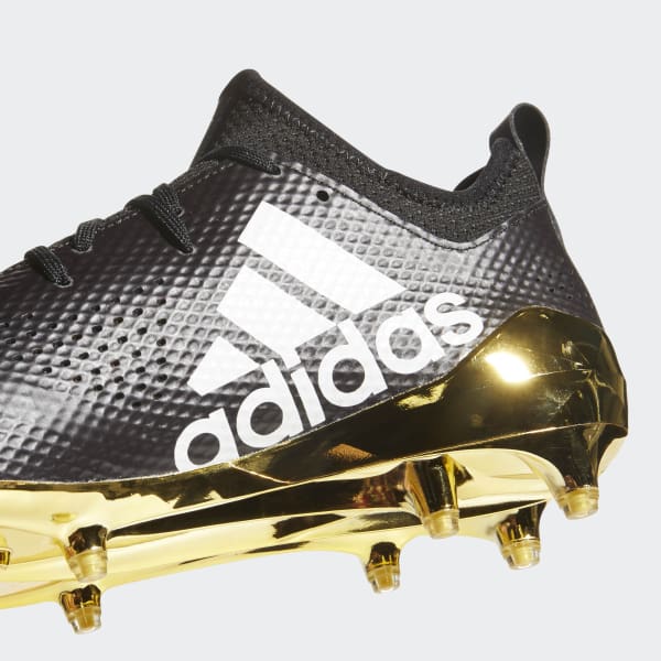 white football cleats with gold bottom