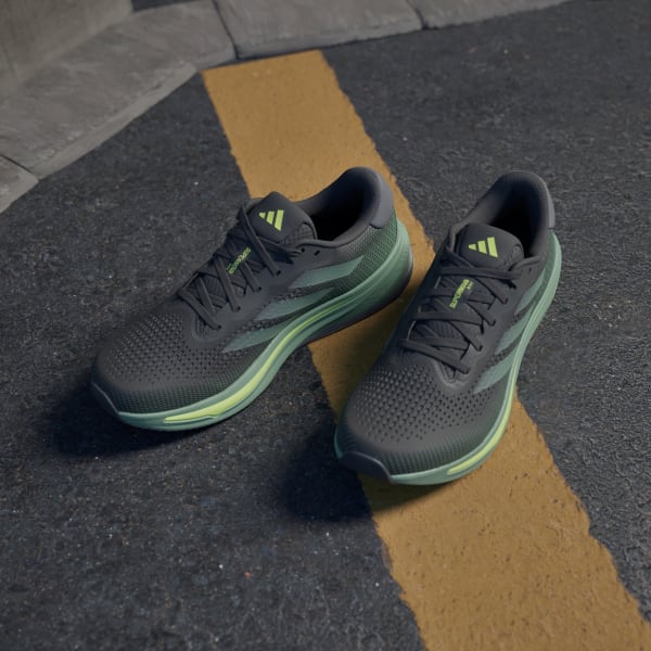 Black and green running shoes top