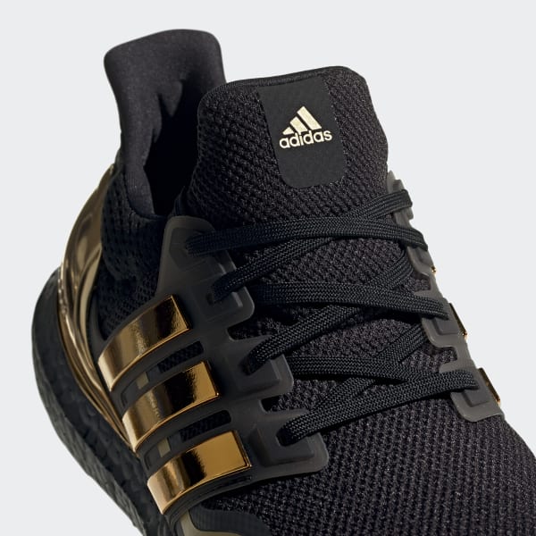 adidas black shoes with gold stripes
