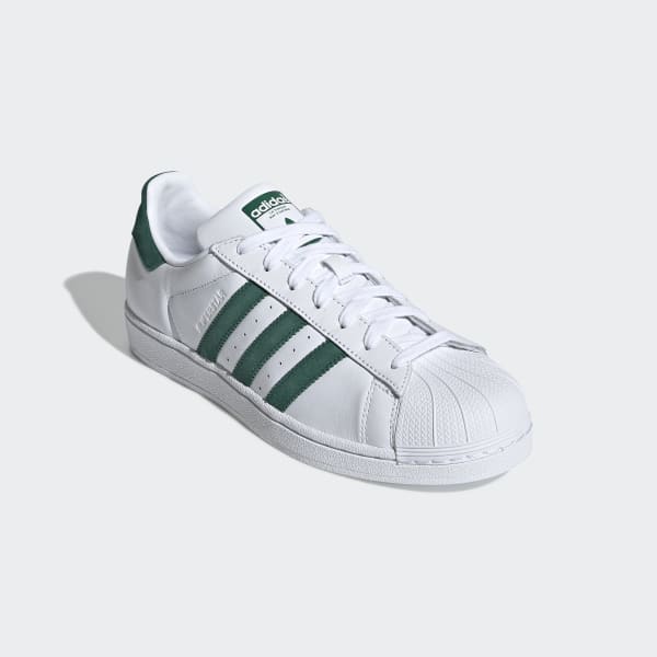 white adidas trainers with green stripes