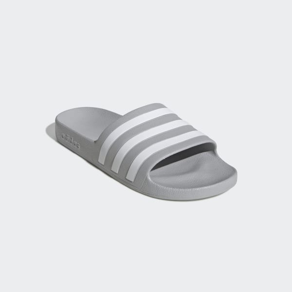 grey and white adidas slides