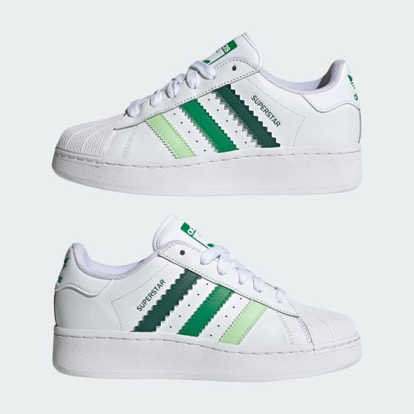 White adidas shoes with best sale green stripes