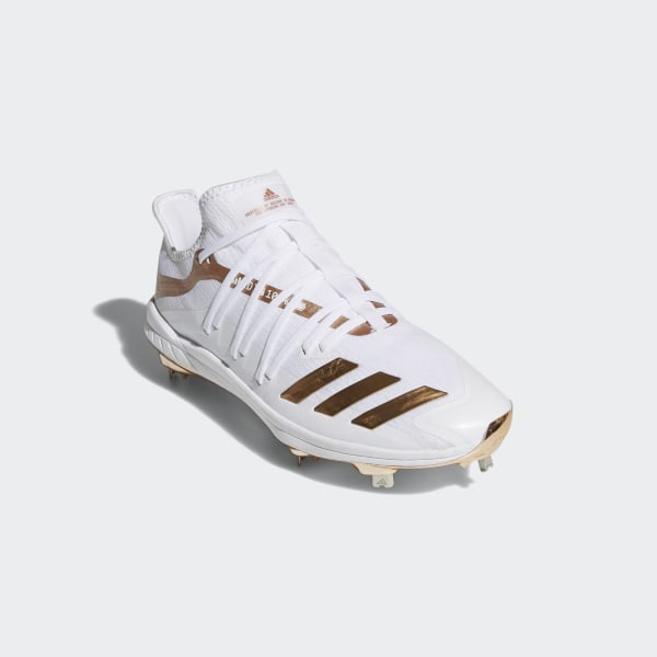 white and gold metal cleats