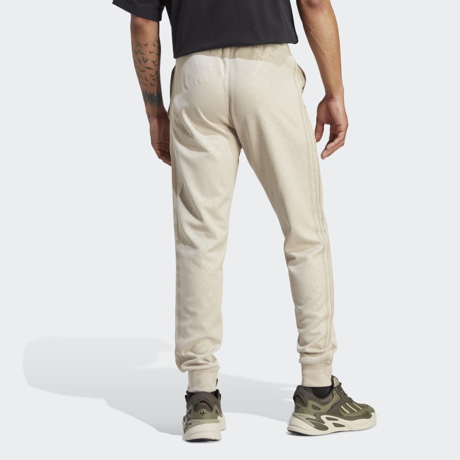adidas Graphics Monogram SST Track Pants - Beige | adidas UAE