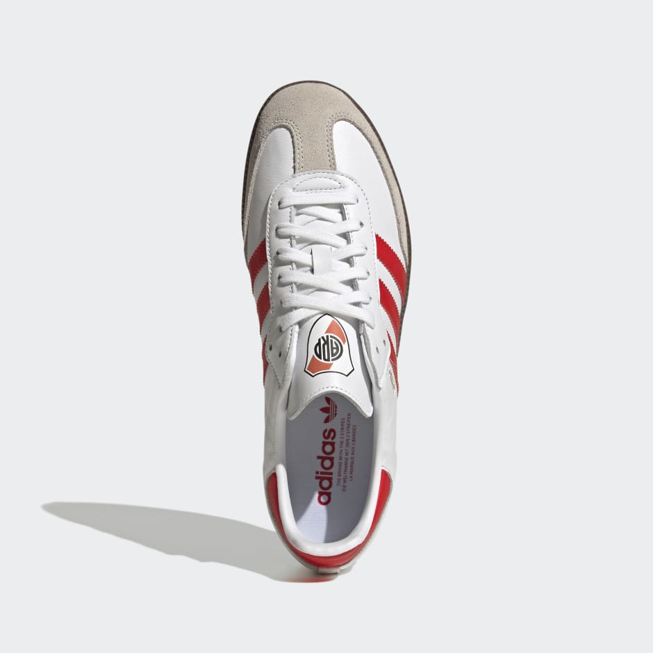 Red adidas shoes with white stripes online