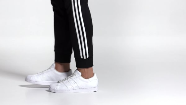 $60 Black And White Striped Standard Adidas Superstar Sneakers Teamed With  Black Sportswear Pants With A White Side Stripe Detail And…
